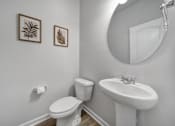 Thumbnail 8 of 19 - Modern bathroom with mirror, toilet, and sink in Indian Trail townhome