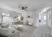 Thumbnail 11 of 19 - Open-concept living space with grey carpet and white sofa in Indian Trail, NC pet-friendly townhome