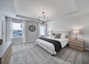 Thumbnail 12 of 19 - Spacious bedroom with large bed, chandelier, and windows in pet-friendly townhome in Indian Trail, NC