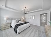 Thumbnail 13 of 19 - Spacious bedroom with large bed and chandelier in pet-friendly townhome in Indian Trail, NC