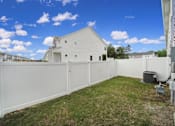 Thumbnail 18 of 19 - Yard with white fence and house in background at pet-friendly townhome in Indian Trail, NC
