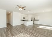 Thumbnail 40 of 75 - A spacious kitchen and living room with a ceiling fan and lighting.