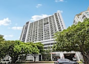 Thumbnail 29 of 30 - Luxury high-rise exterior of MB Station apartments in Miami's Coral Way neighborhood, offering modern studio, one-, and two-bedroom apartment homes near Brickell and Coral Gables.