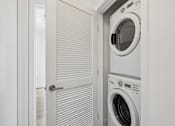 Thumbnail 11 of 30 - In-home front-loading washer and dryer at MB Station apartments in Miami, providing added convenience for everyday living.