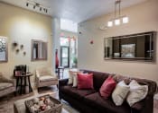 Thumbnail 17 of 22 - The Club house with a couch chairs and a coffee table At Metropolitan Apartments in Little Rock, AR