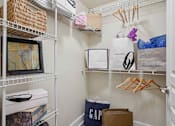 Thumbnail 11 of 22 - Pet-Friendly Rentals in North Little Rock, AR – Metropolitan – A white closet with a GAP bag and a MINE WEST bag.