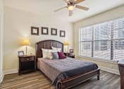 Thumbnail 10 of 22 - 1, 2 -Bedroom Apartments for Rent in North Little Rock, AR – Metropolitan– A bedroom with a bed, nightstands, and a ceiling fan.