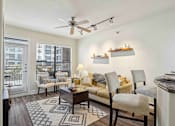 Thumbnail 6 of 22 - Apartments for Rent in North Little Rock, AR 72114– Metropolitan-   A living room with a couch, chairs, and a rug.