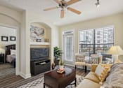 Thumbnail 7 of 22 - 1, 2 -Bedroom Apartments for Rent in North Little Rock, AR – Metropolitan– A living room with a brown carpet and a white ceiling fan.
