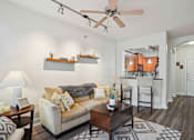 Thumbnail 5 of 22 - Pet-Friendly Rentals in North Little Rock, AR – Metropolitan – A living room with a couch, a coffee table, and a ceiling fan.