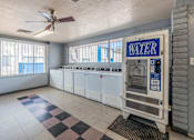 Thumbnail 26 of 37 - A room with a water heater and a ceiling fan.