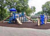 Thumbnail 4 of 13 - Colorful playground with slides and swings at Mirador at Idlewood Apartments near Stone Mountain and Kirkwood