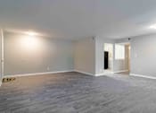 Thumbnail 14 of 24 - Unfurnished living space with large window and wood-style plank floors near Briarcliff.