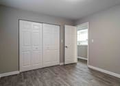 Thumbnail 16 of 24 - Bedroom with double-door closet and neutral paint in Atlanta rental apartment.