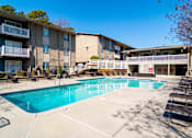 Thumbnail 20 of 24 - Swimming pool with sundeck and seating in community-oriented Atlanta apartments