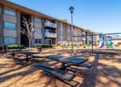Thumbnail 21 of 24 - Mirador at Peachtree Apartments photo of picnice tables in front of playground