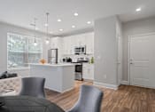Thumbnail 6 of 24 - Dining space with bar seating and pendant lighting in a renovated Atlanta apartment.