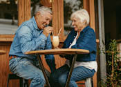 Thumbnail 13 of 18 - Social senior living at Sage 5430: couple laughing and enjoying coffee near Duluth and Alpharetta
