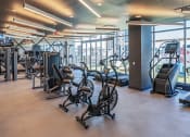 Thumbnail 15 of 31 - 3thirty3 new rochelle ny apartment high rise photo of large fitness center with cardio and strength training equipment such as exercise bicycles and weight machines