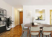Thumbnail 16 of 66 - A dining room with a wooden table and chairs.
