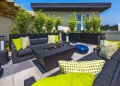 Thumbnail 11 of 36 - Seattle, WA, Apartments with In-Unit Washer and Dryer - Origin - Firepit with Lounge Seating and Outdoor Lamps on Rooftop Patio