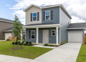Thumbnail 1 of 22 - a blue house with a sidewalk in front of it
