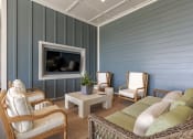Thumbnail 15 of 22 - a living room with blue walls and a couch and chairs