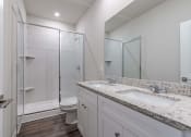 Thumbnail 8 of 22 - a bathroom with a sink and a shower and a toilet