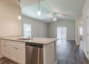 Thumbnail 10 of 22 - an empty kitchen with a counter top and a stainless steel dishwasher