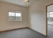 Thumbnail 15 of 28 - One-Bedroom Apartments in Fremont, WA - Epicenter - Bedroom with Carpeting, Window, Ceiling Light, and Air-Conditioning