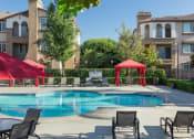Thumbnail 12 of 24 - Dazzling Pool Area with Private Cabanas, Comfy Lounger Chairs, and Seating for All