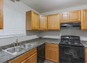 Thumbnail 2 of 13 - The element 4411, Macon, GA Apartment  kitchen with black appliances