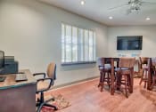 Thumbnail 13 of 20 - Beaumont, TX Apartments – Breakwater Bay - Business Center with tables, chairs, tv, and computer
