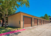 Thumbnail 22 of 24 - a long row of garages with cars parked next to them
