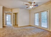 Thumbnail 8 of 25 - Living room with carpet, ceiling fan, glass doors and walkway