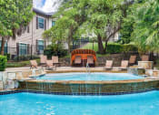 Thumbnail 2 of 25 - Mission oaks pool with waterfall surrounded by trees and beach chairs and club house