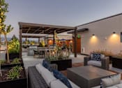 Thumbnail 19 of 41 - Outdoor resident terrace surrounded by greenery at Santana Terrace apartments in Santa Clara, CA