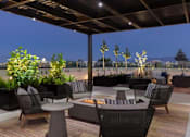 Thumbnail 18 of 41 - Covered rooftop lounge with comfortable outdoor seating at Santana Terrace apartments in Silicon Valley