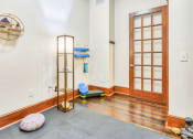 Thumbnail 3 of 23 - yoga room with hardwood floors and glass wood paneled doors