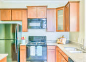 Thumbnail 1 of 23 - open concept kitchen with granite countertops, stainless steel appliances and oak cabinetry