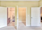 Thumbnail 11 of 23 - two open doors leading to a bathroom and large walk in closet