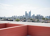 Thumbnail 5 of 78 - the view of the city from the rooftop terrace of a building with a bench
