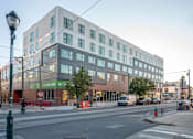 Thumbnail 38 of 78 - a building on the corner of a city street