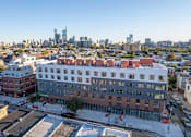 Thumbnail 74 of 78 - an aerial view of a building with a city in the background