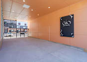 Thumbnail 6 of 78 - A sign for GIO is on the wall in a parking garage.