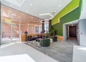 Thumbnail 3 of 78 - A modern interior with a glass wall and a green accent wall.