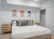Thumbnail 61 of 78 - a bedroom with a bed and paintings on the wall