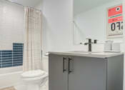 Thumbnail 52 of 78 - a bathroom with a sink and a toilet and a shower