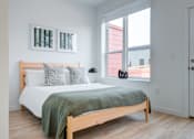 Thumbnail 43 of 78 - a bedroom with a bed and two windows