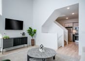 Thumbnail 20 of 78 - a living room with a tv and a table
